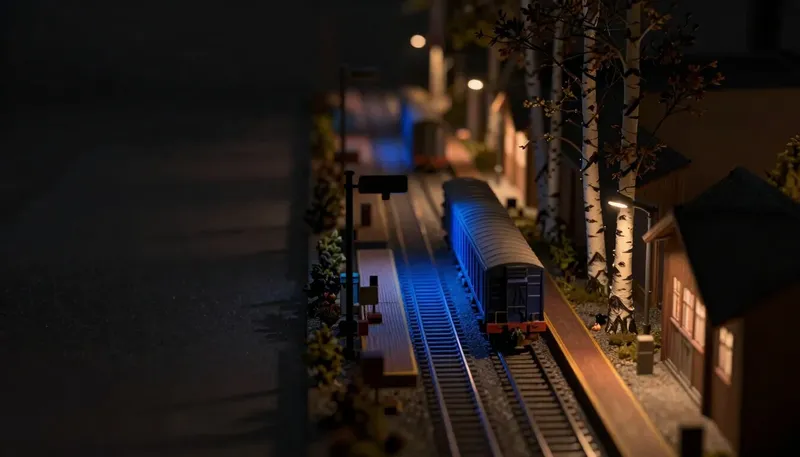 A central turntable routing one car to many sidings sits beside a glowing blue direct spur with its own reserved platform, showing broad routing against a straight line to features vendors keep for themselves.